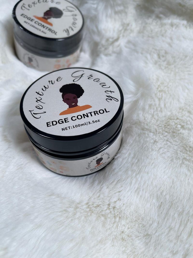Texture Growth Edge Control jars on a soft white fur background, lids showing the label