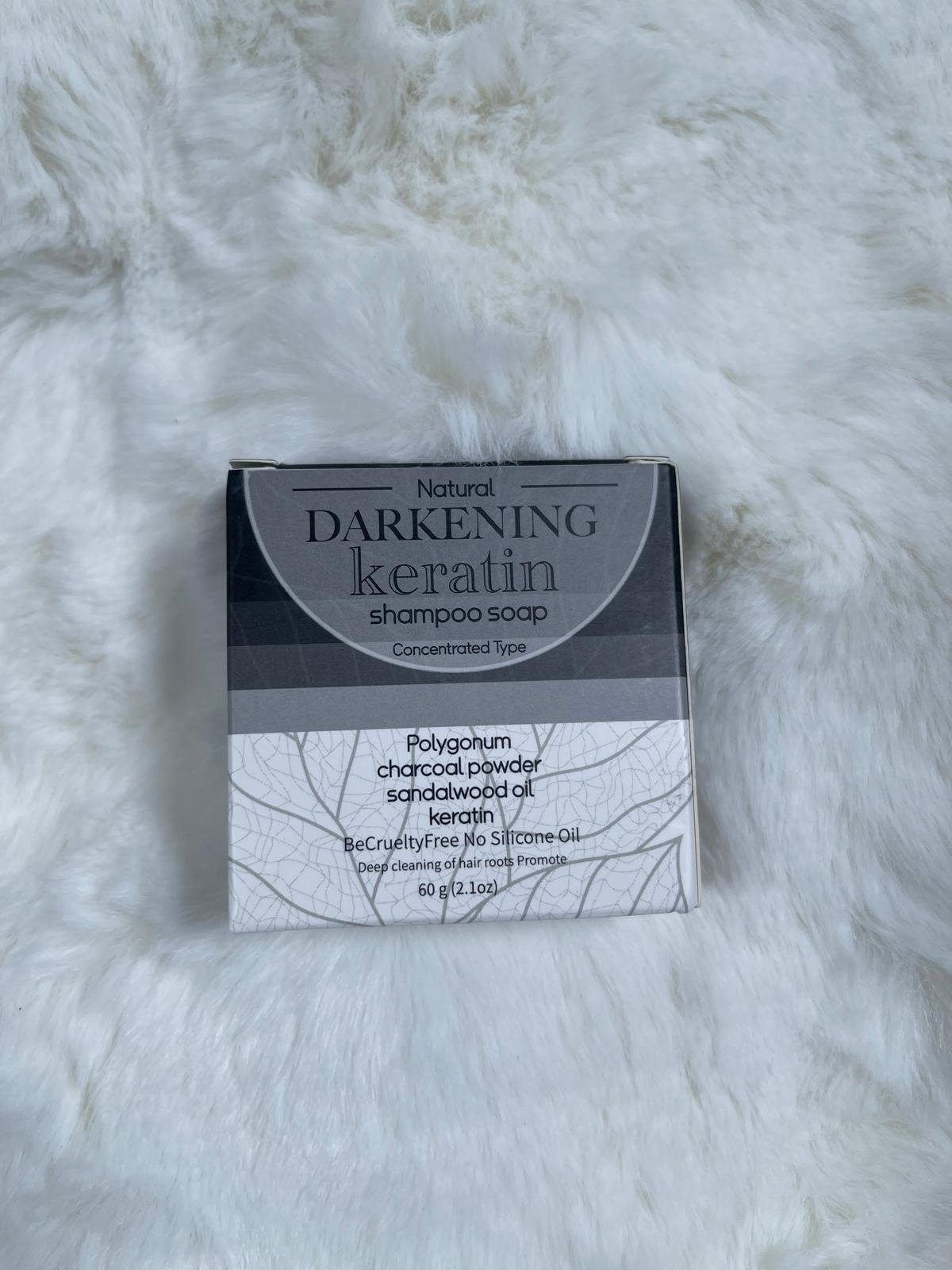 Darkening Keratin Shampoo Soap box on a white fur background